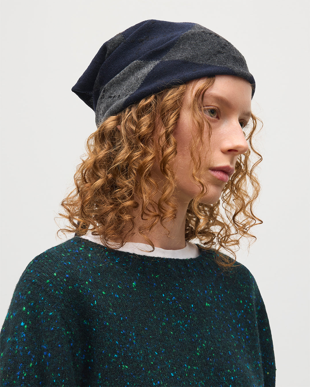 FEMALE MODEL WEARING JOHNSTONS OF ELGIN CLAN BANDANA NAVY 100% CASHMERE ON A MALE MODEL OVER A FIR DONEGAL CAIRN CASHMERE SWEATER HAP03612JU1613ONE