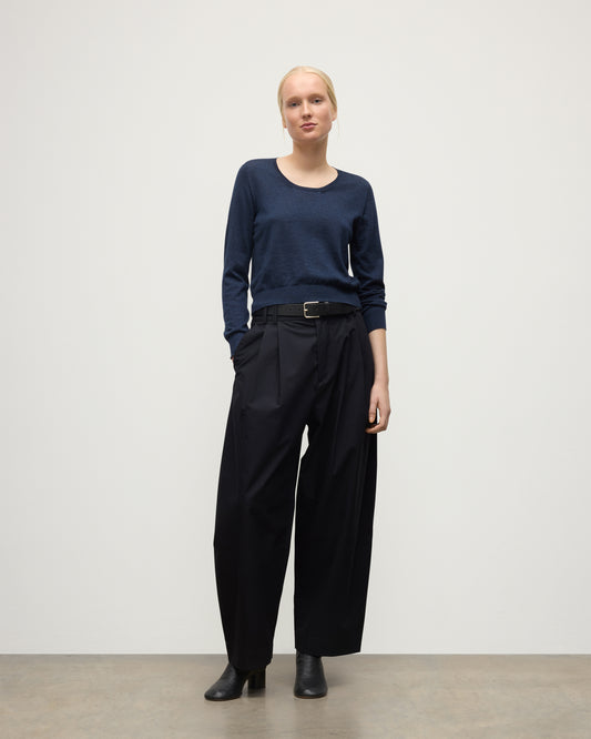 MODEL WEARING JOHNSTONS OF ELGIN WOMENS ELLA SCOOP SWEATER NAVY WITH BLACK TROUSERS AND BOOTS KAI05723HD7350