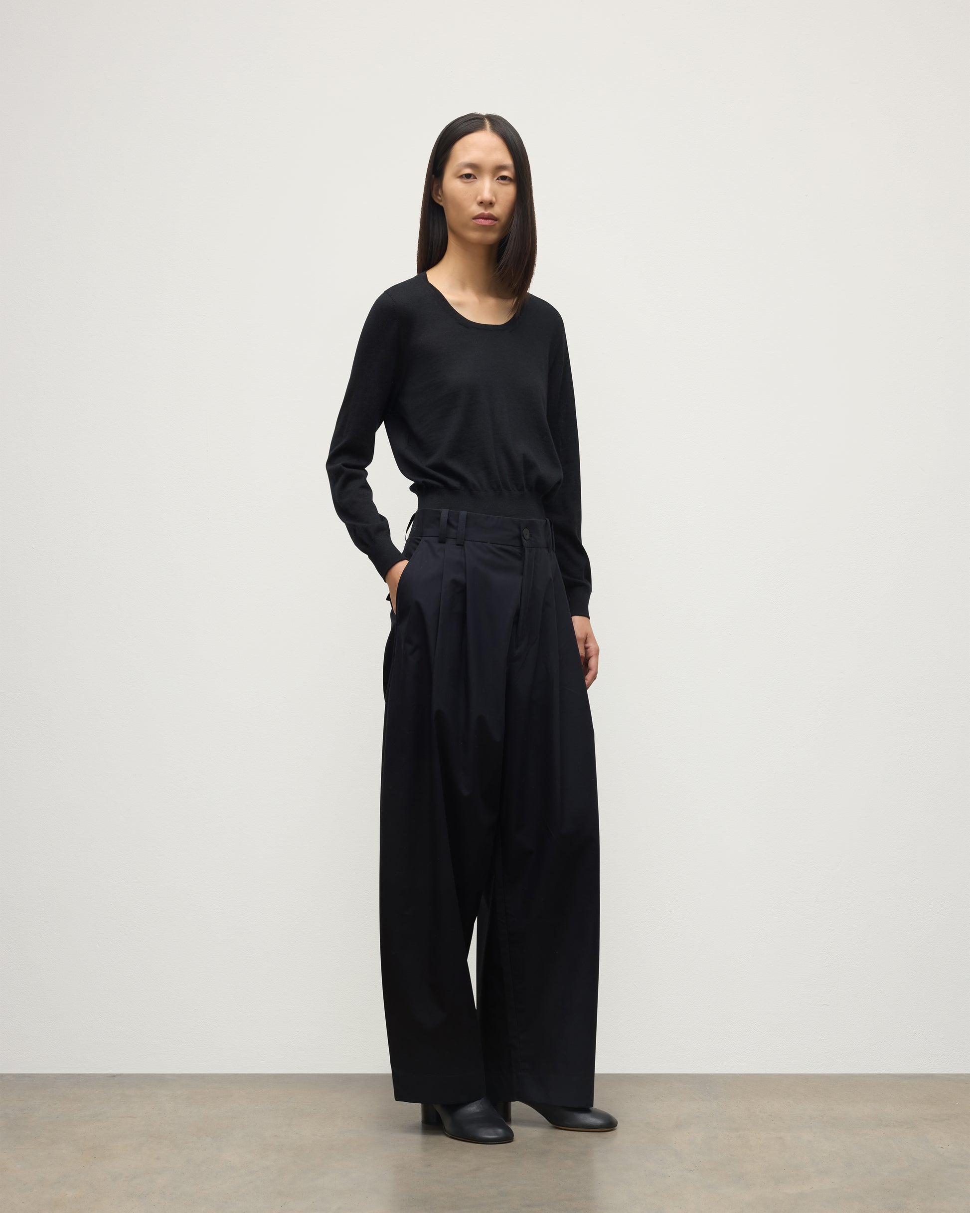 MODEL WEARING JOHNSTONS OF ELGIN WOMENS ELLA SCOOP SWEATER BLACK WITH BLACK TROUSERS KAI05723SA7146