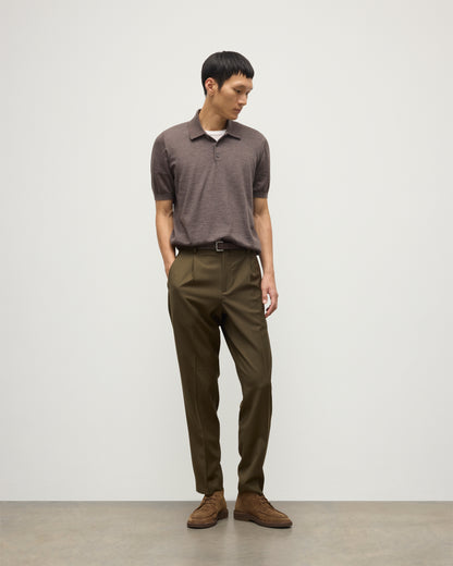 MODEL WEARS JOHNSTONS OF ELGIN MENS FIN SHORT SLEEVE SUPERFINE POLOSHIRT LIGHT BROWN OVER A WHITE T-SHIRT WITH OLIVE GREEN TROUSERS KAI05741HB7092