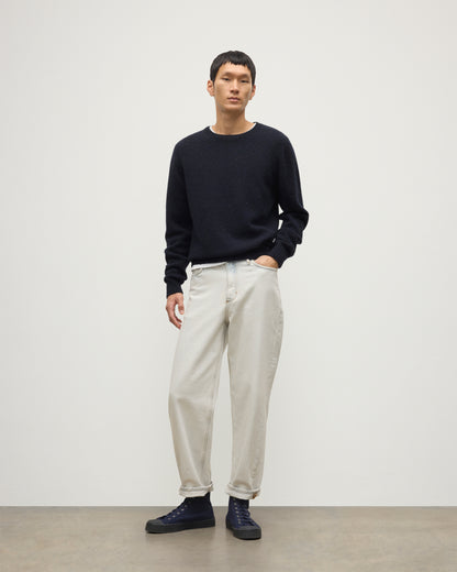 MODEL WEARS JOHNSTONS OF ELGIN  MENS TIREE CREW SWEATER BLUE 100% DONEGAL CASHMERE WITH WHITE JEANS KAI05755HD7348