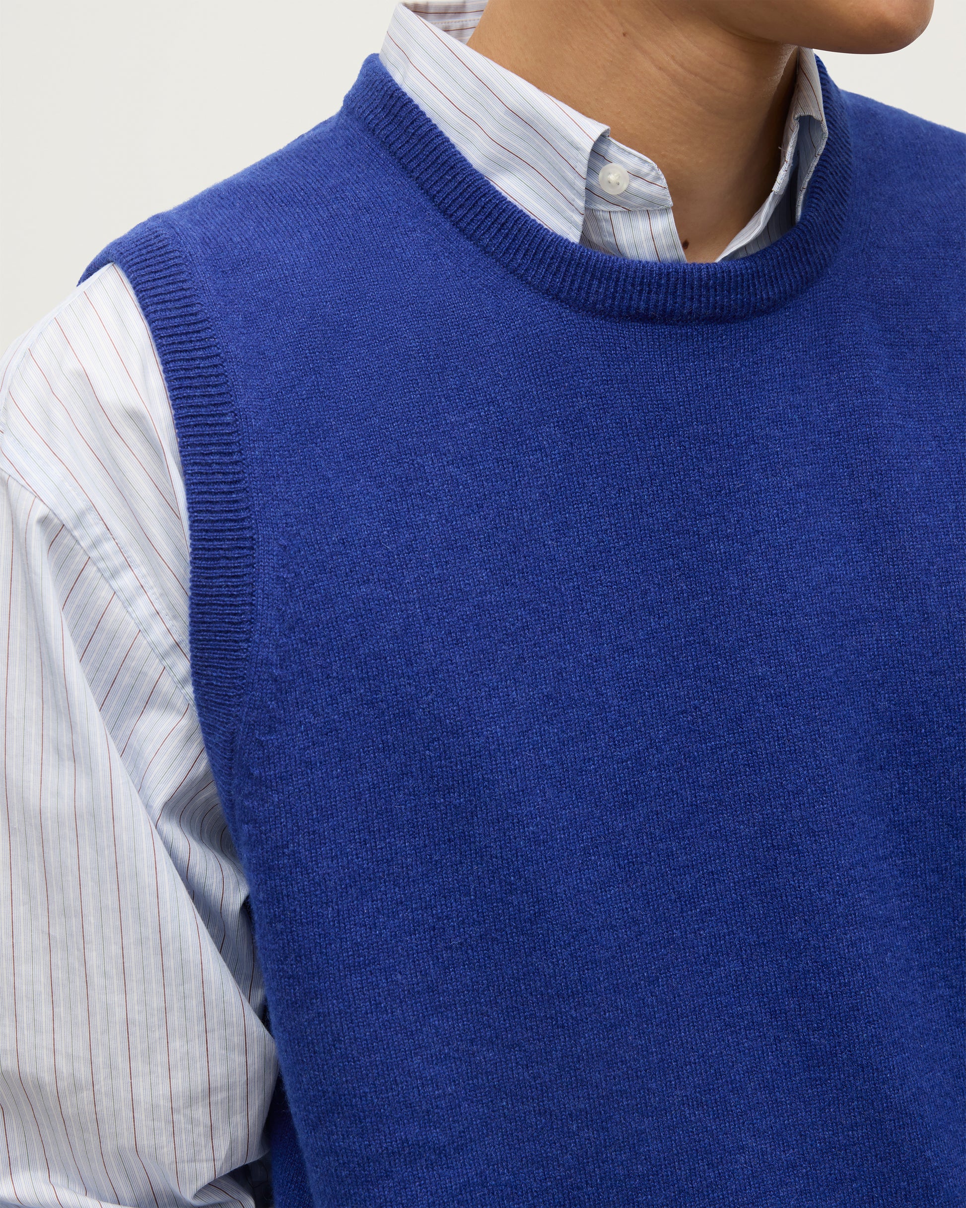 MENS LENNOX SLEEVELESS CREW BLUE 100% CASHMERE, BY JOHNSTONS OF ELGIN, WORN OVER A LIGHT BLUE SHIRT KAP05243SD5326