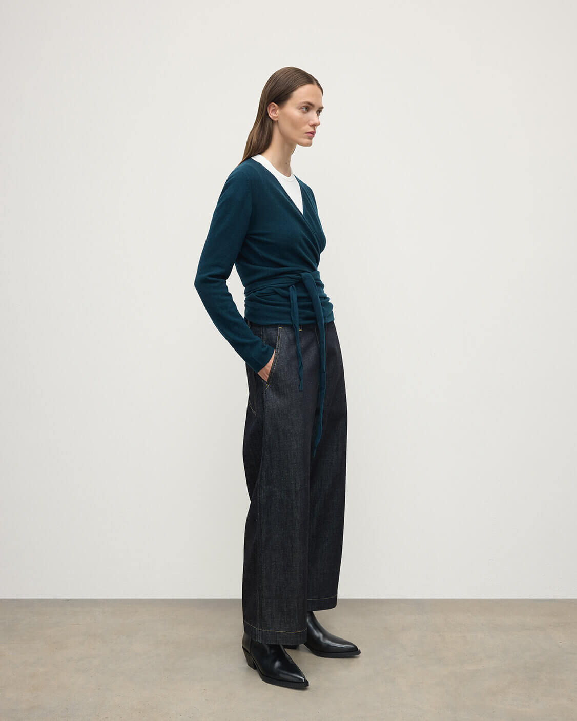 Model wearing Johnstons of Elgin AW25 Women's Knitwear Bottle Green Ballet Wrap Green Cashmere Cardigan Side View KAP05408SC7341