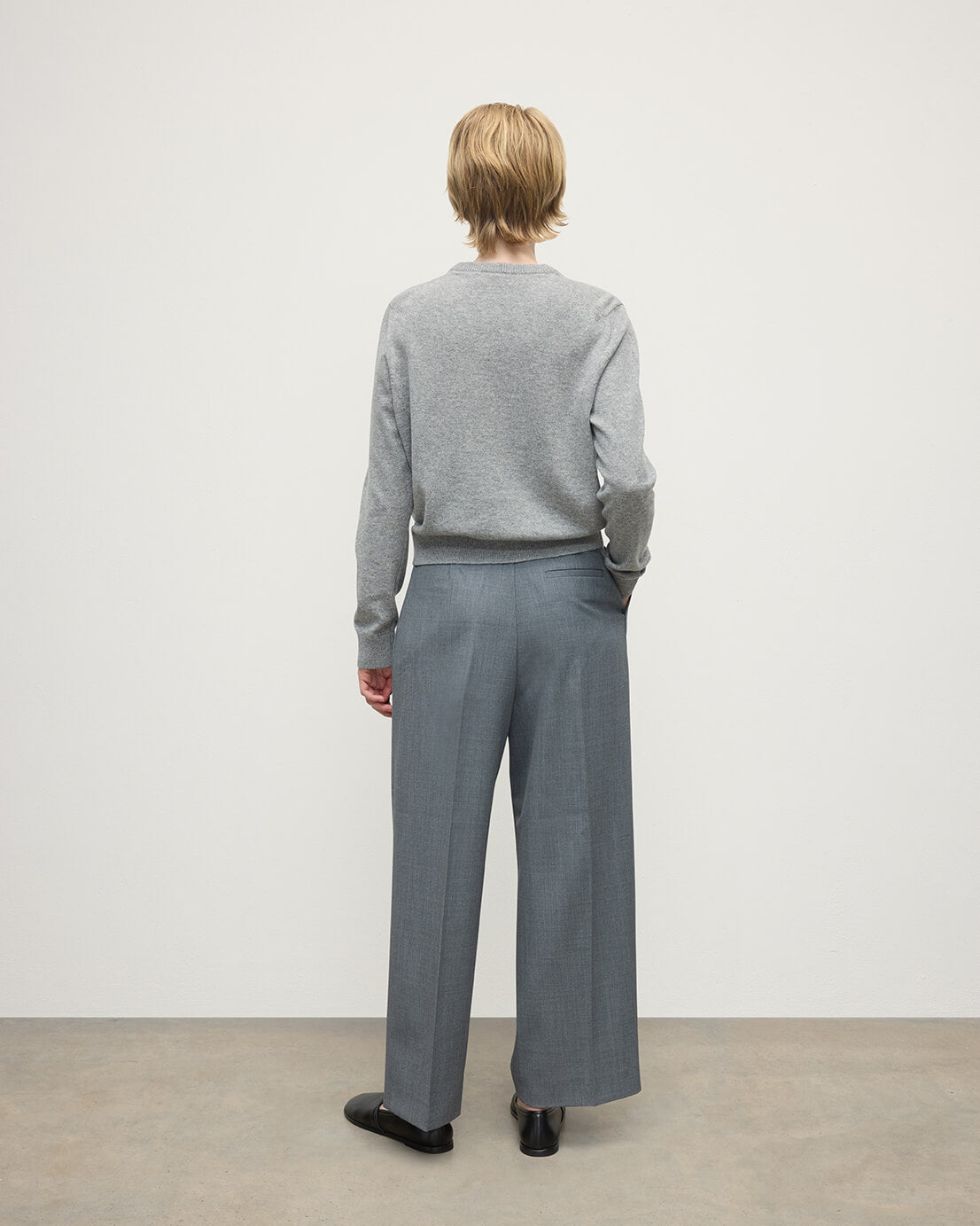 Model wears Johnstons of Elgin AW25 Women's Knitwear Light Grey Classic Cashmere Grey Round Neck Jumper Back KAP05572HA0308