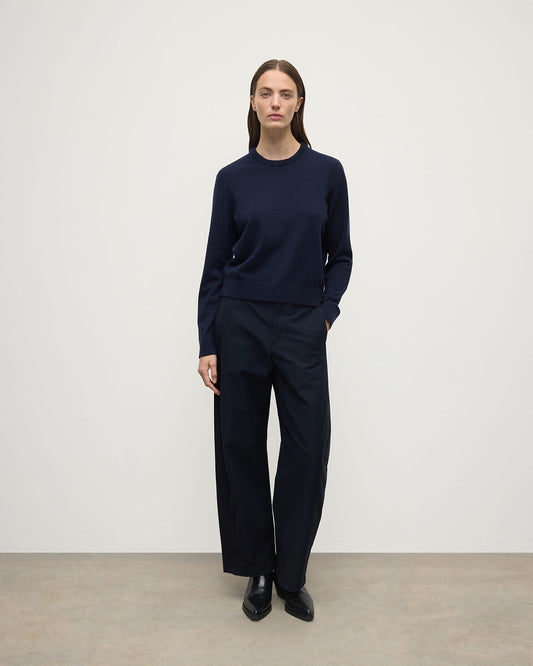 Model wearing Johnstons of Elgin AW25 Women's Knitwear Dark Navy Classic Cashmere Navy Round Neck Jumper front View  KAP05572SD7666