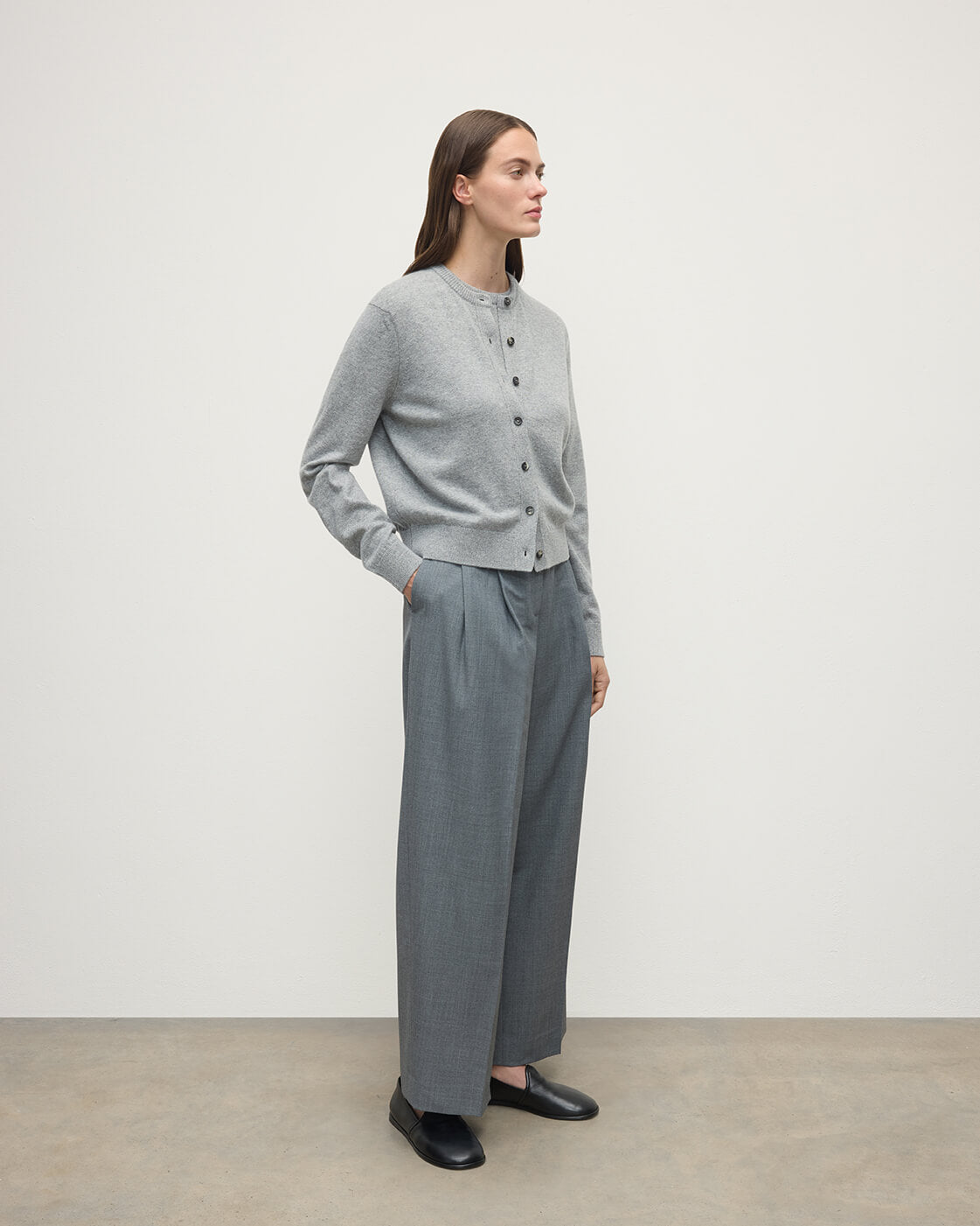 Model wears Johnstons of Elgin AW25 Women's Knitwear Light Grey Classic Cashmere Grey Cardigan Side KAP05573HA0308