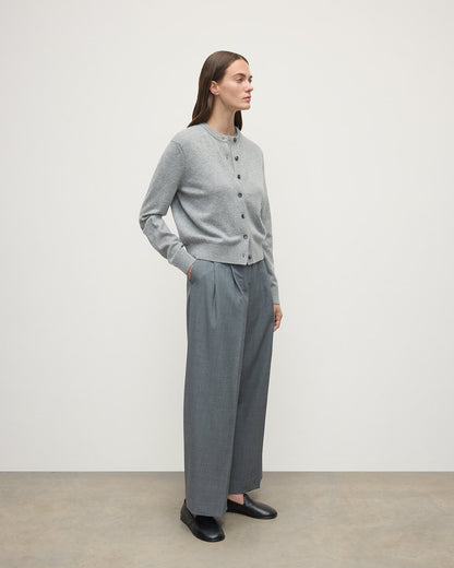 Model wears Johnstons of Elgin AW25 Women's Knitwear Light Grey Classic Cashmere Grey Cardigan Side KAP05573HA0308