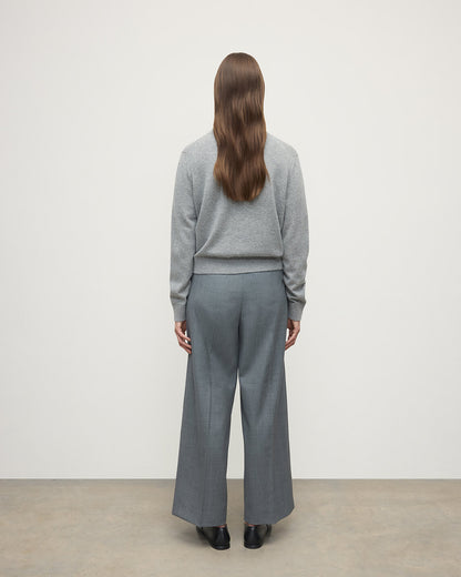 Model wears Johnstons of Elgin AW25 Women's Knitwear Light Grey Classic Cashmere Grey Cardigan Back KAP05573HA0308