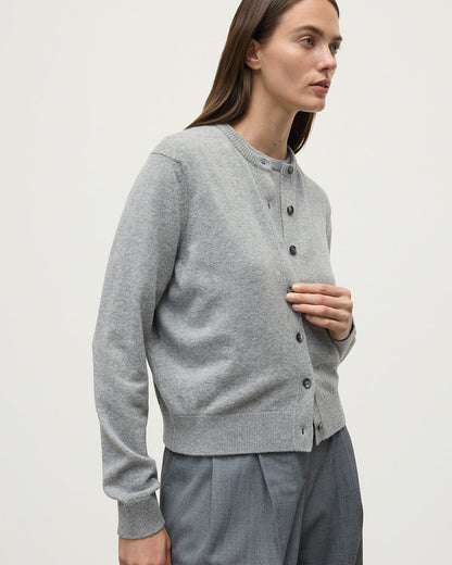 Model wears Johnstons of Elgin AW25 Women's Knitwear Light Grey Classic Cashmere Grey Cardigan Close Up KAP05573HA0308