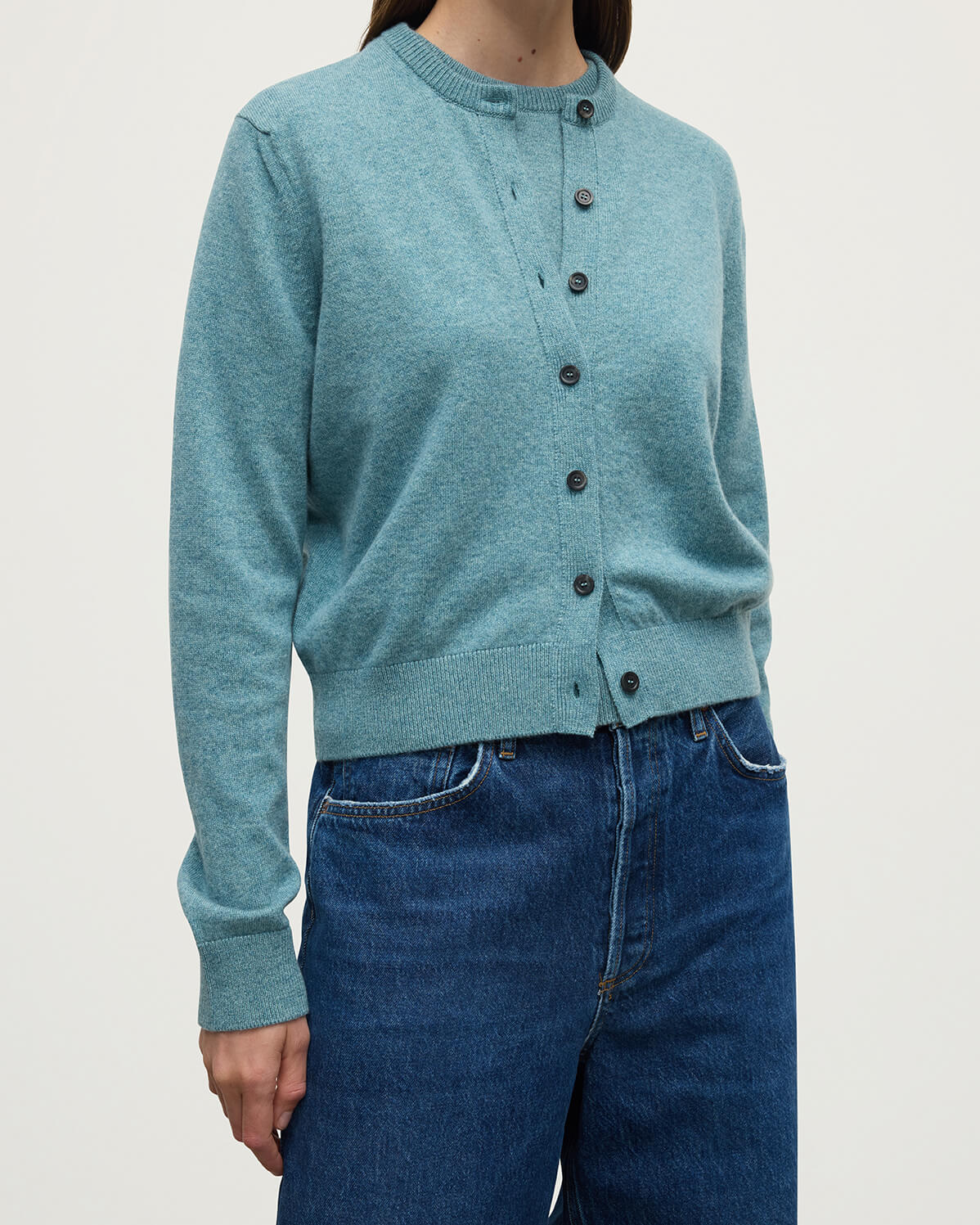 Model wears Johnstons of Elgin AW25 Women's Knitwear Seascape Classic Cashmere Green Cardigan Close Up KAP05573HC0038