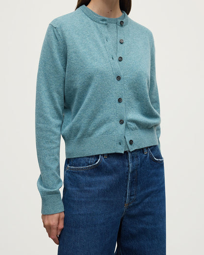 Model wears Johnstons of Elgin AW25 Women's Knitwear Seascape Classic Cashmere Green Cardigan Close Up KAP05573HC0038