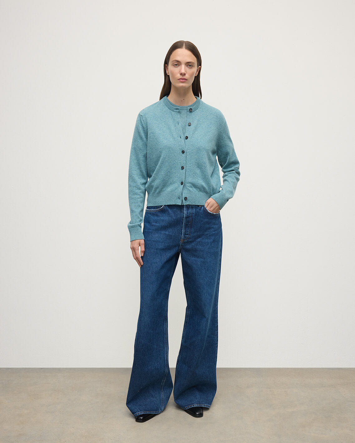 Model wears Johnstons of Elgin AW25 Women's Knitwear Seascape Classic Cashmere Green Cardigan Front KAP05573HC0038
