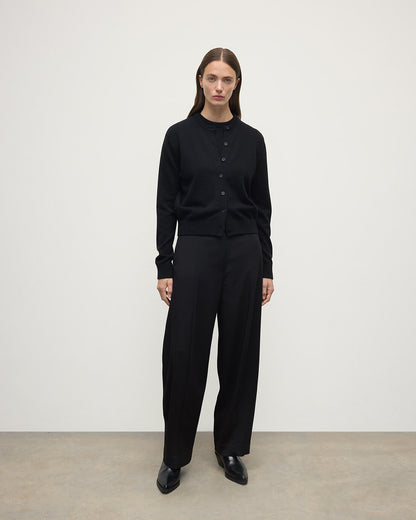 Model wears Johnstons of Elgin AW25 Women's Knitwear Black Classic Cashmere Black Cardigan Front KAP05573SA7210