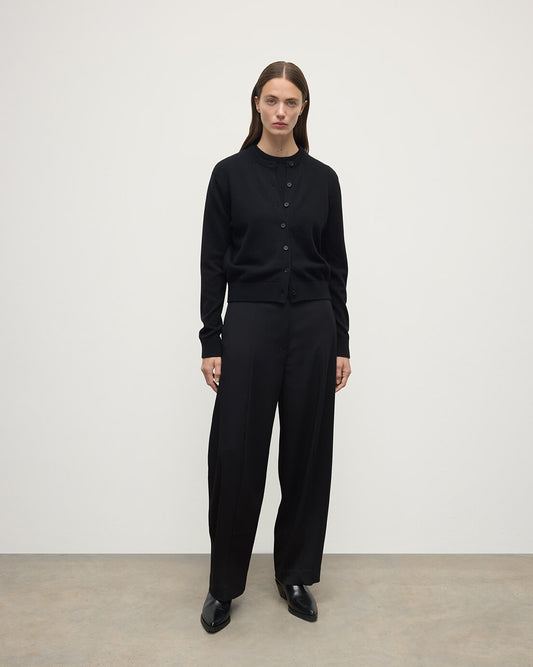 Model wears Johnstons of Elgin AW25 Women's Knitwear Black Classic Cashmere Black Cardigan Front KAP05573SA7210