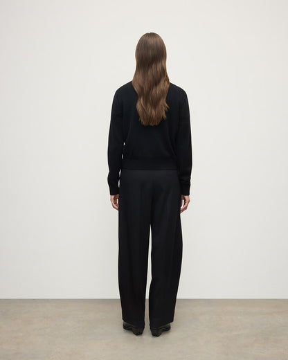 Model wears Johnstons of Elgin AW25 Women's Knitwear Black Classic Cashmere Black Cardigan Back KAP05573SA7210