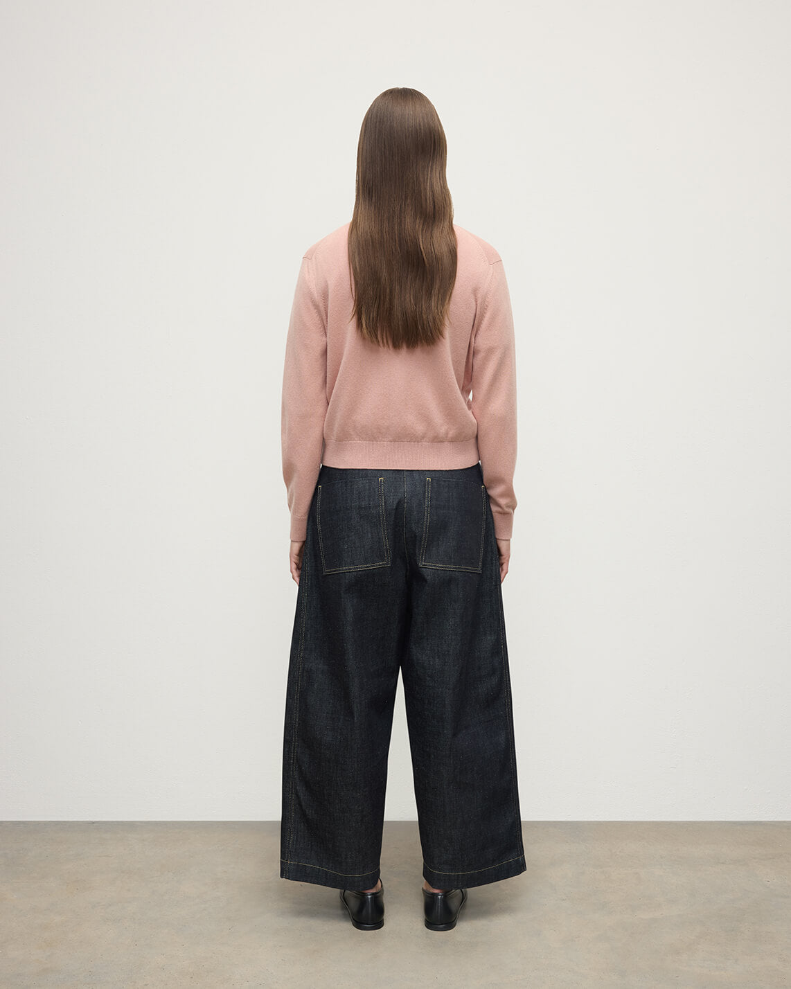 Model wears Johnstons of Elgin AW25 Women's Knitwear Nude Classic Cashmere Pink Cardigan Back KAP05573SE0740