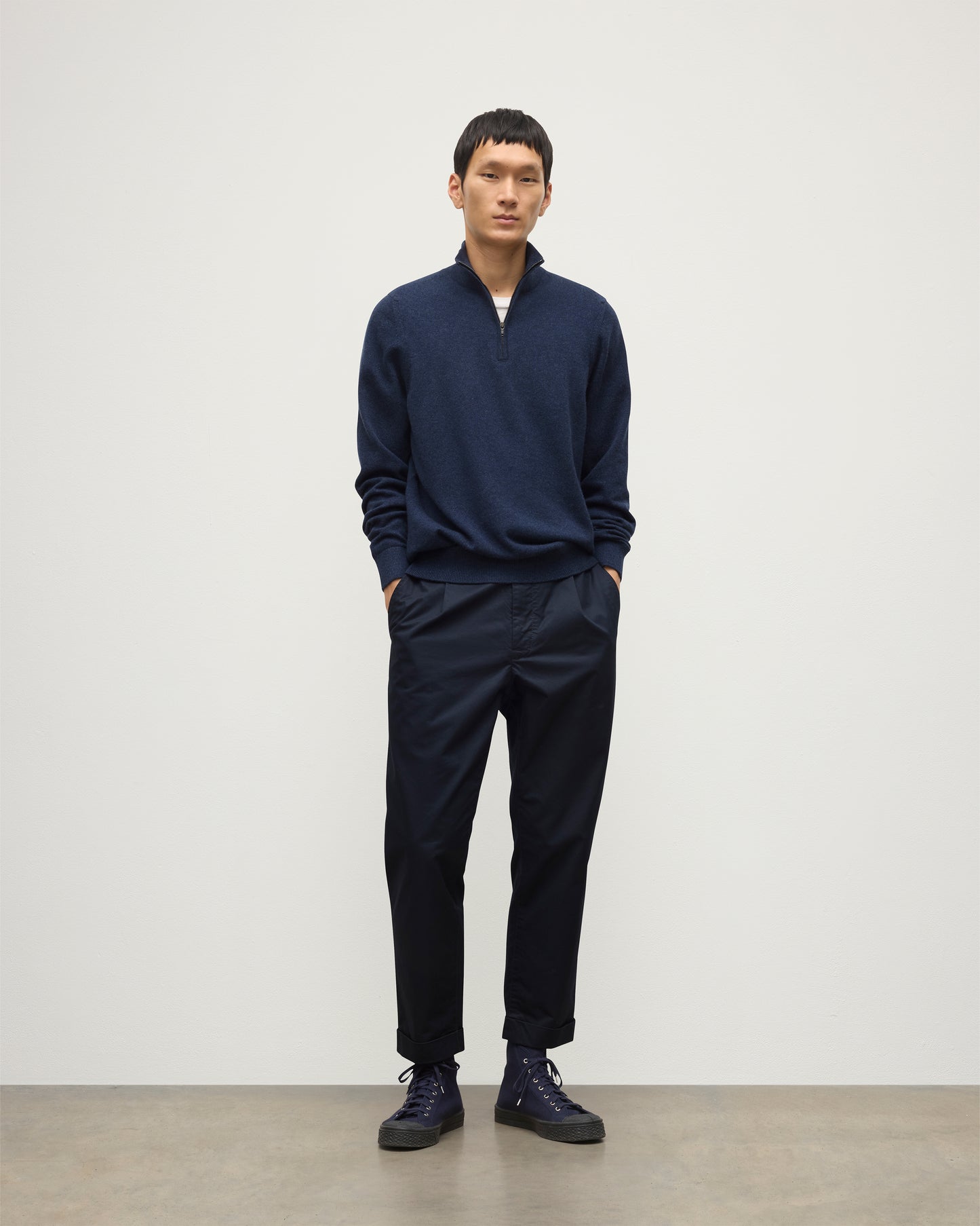 MODEL WEARS JOHNSTONS OF ELGIN MENS RORY CLASSIC HALF ZIP CLASSIC SWEATER 100% CASHMERE  OVER A WHITE T-SHURT WITH NAVY TROUSERS KAP05695HD7350