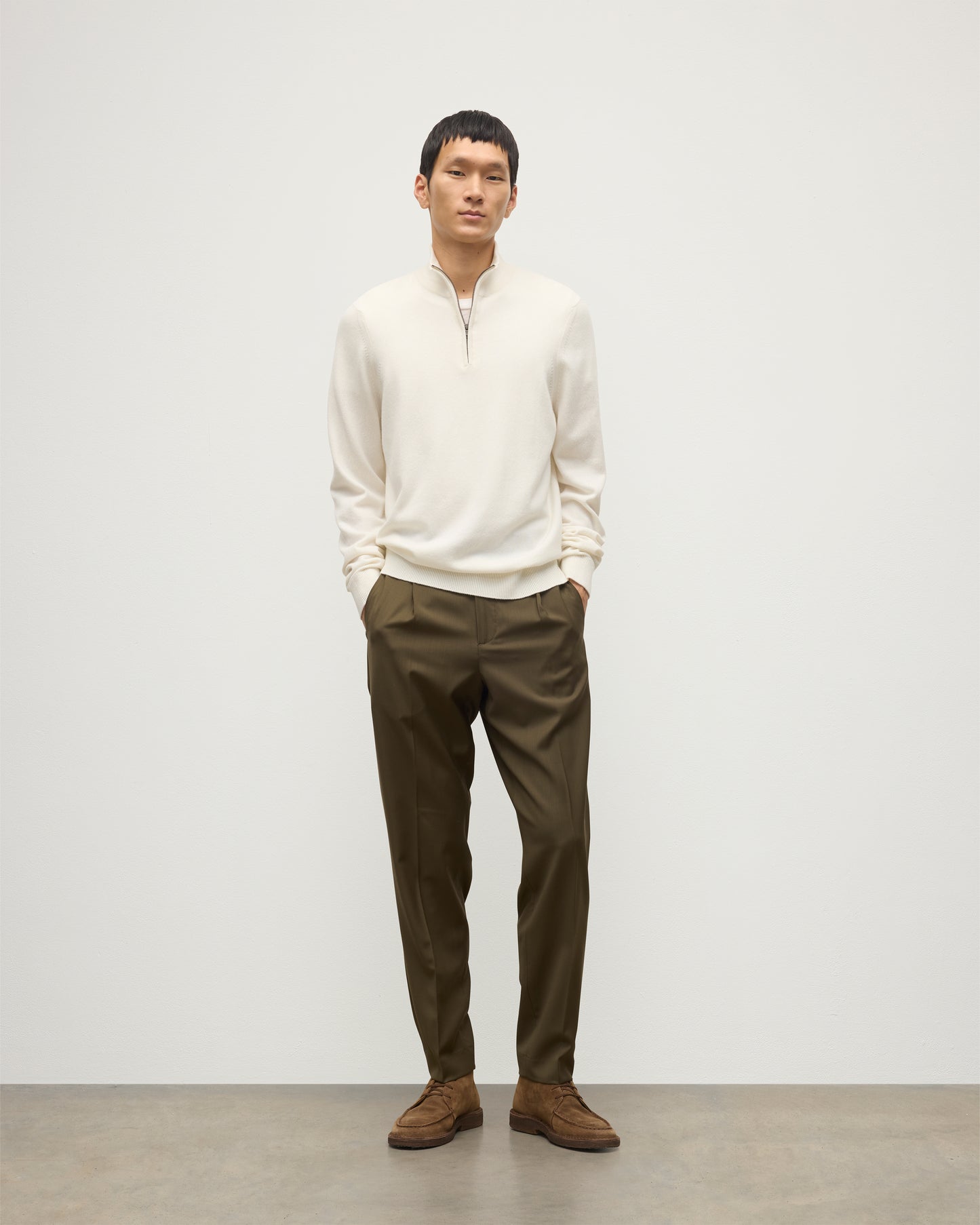 MODEL WEARS JOHNSTONS OF ELGIN MENS RORY CLASSIC HALF ZIP CLASSIC SWEATER 100% CASHMERE OVER A WHITE T0SHIRT WITH OLIVE GREEN TROUSERS KAP05695SA0606