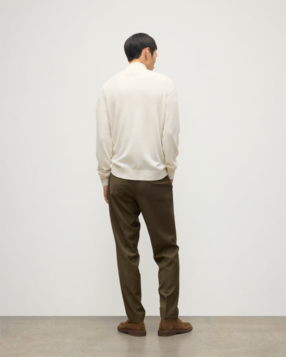 MODEL WEARS JOHNSTONS OF ELGIN MENS RORY CLASSIC HALF ZIP CLASSIC SWEATER 100% CASHMERE OVER A WHITE T-SHIRT WITH OLIVE GREEN TROUSERS KAP05695SA0606