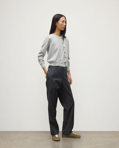 MODEL WEARS JOHNSTONS OF ELGIN WOMENS IRIS CLASSIC CREW CARDIGAN GREY WITH GREY TROUSERS AND TRAINERS  100% CASHMERE KAP05704HA0399