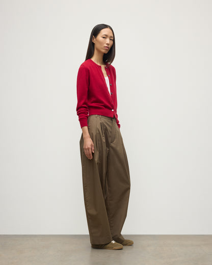 MODEL WEARS JOHNSTONS OF ELGIN WOMENS IRIS CLASSIC CREW CARDIGAN RED 100% CASHMERE OVER A WHITE VEST WITH BROWN TROUSERS AND TRAINERS  KAP05704SE5325