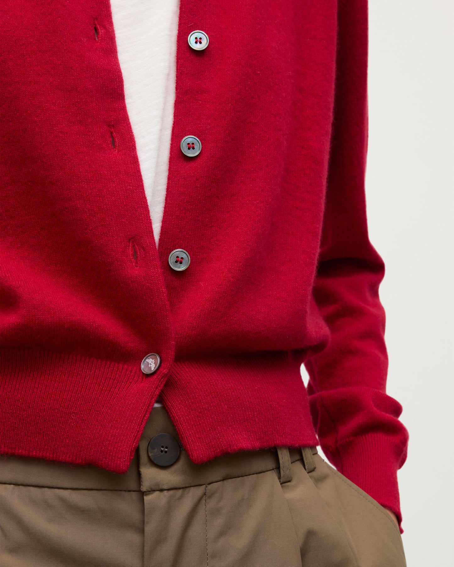 MODEL WEARS JOHNSTONS OF ELGIN WOMENS IRIS CLASSIC CREW CARDIGAN RED 100% CASHMERE OVER A WHITE VEST WITH BROWN TROUSERS KAP05704SE5325