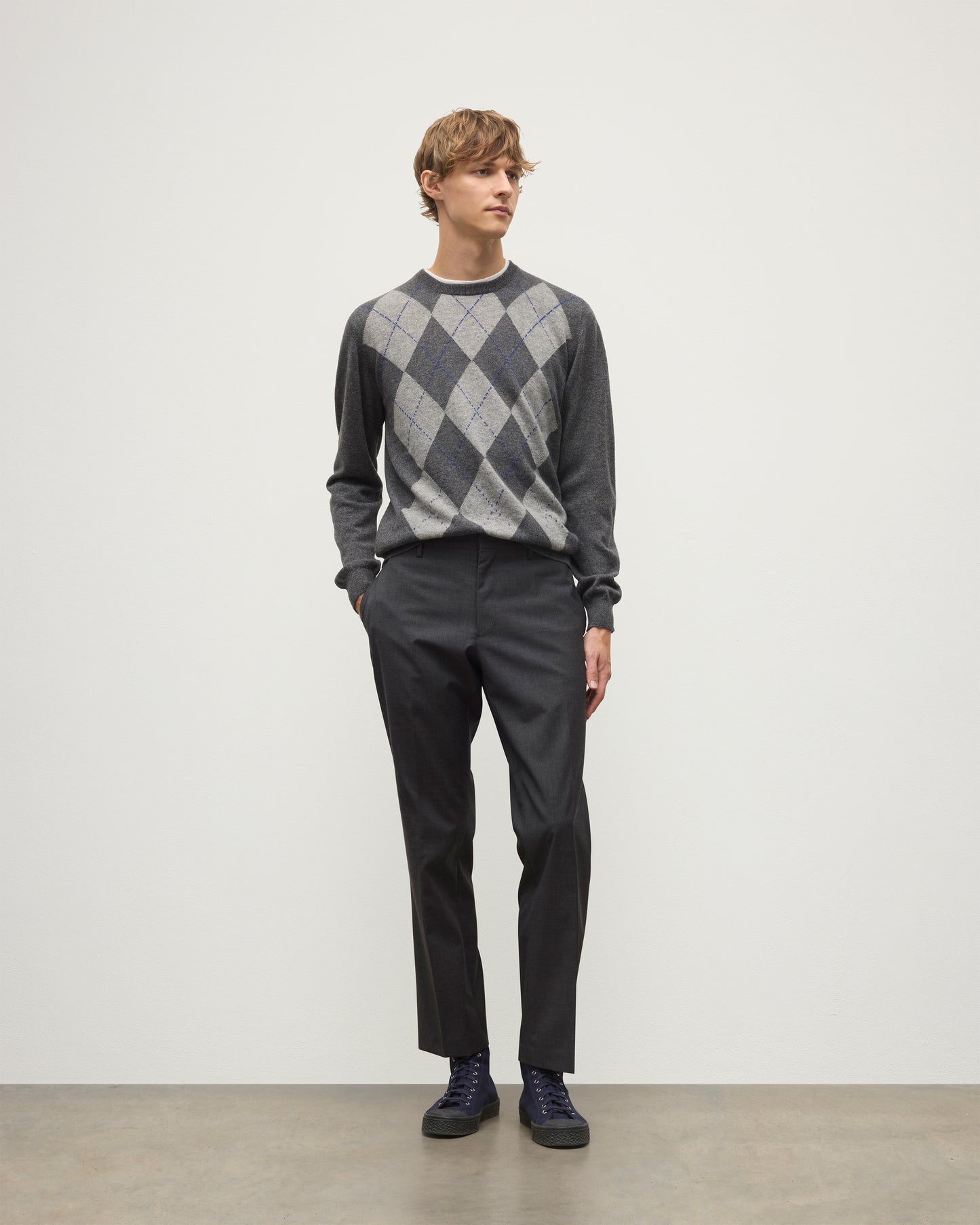 MODEL WEARS JOHNSTONS OF ELGIN MENS ARGYLL CREW SWEATER GREY & BROWN 100% CASHMERE WITH GREY TROUSERS KAP05747JU1601