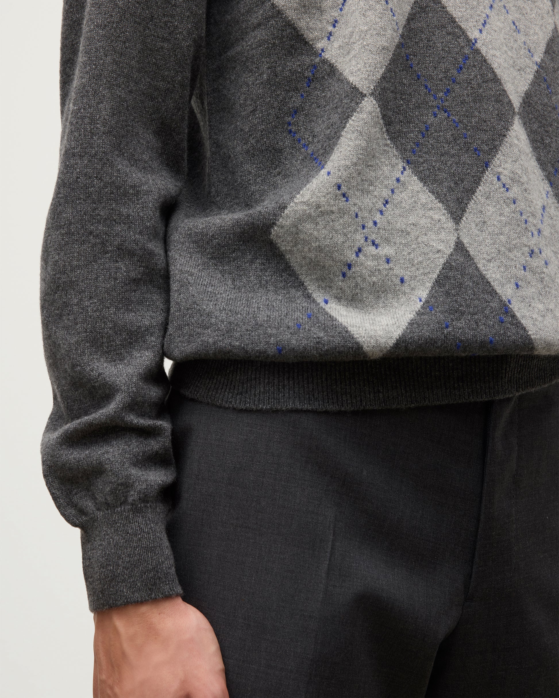 MODEL WEARS JOHNSTONS OF ELGIN MENS ARGYLL CREW SWEATER GREY & BROWN 100% CASHMERE WITH GREY TROUSERS KAP05747JU1601