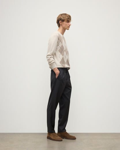 MODEL WEARS JOHNSTONS OF ELGIN MENS ARGYLL CREW SWEATER NATURAL 100% CASHMERE WITH NAVY TROUSERS KAP05747JU1602