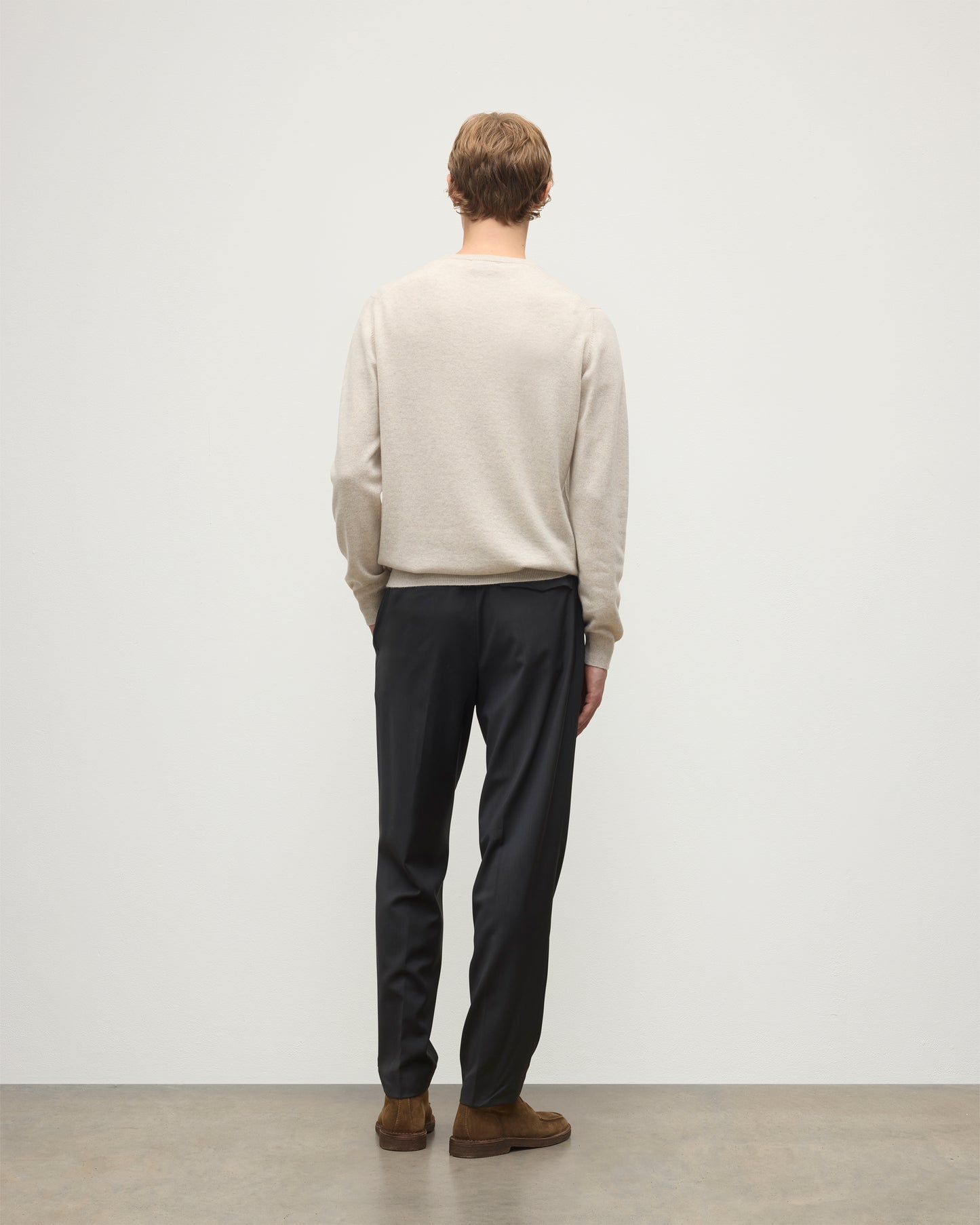 MODEL WEARS JOHNSTONS OF ELGIN MENS ARGYLL CREW SWEATER NATURAL 100% CASHMERE WITH NAVY TROUSERS KAP05747JU1602