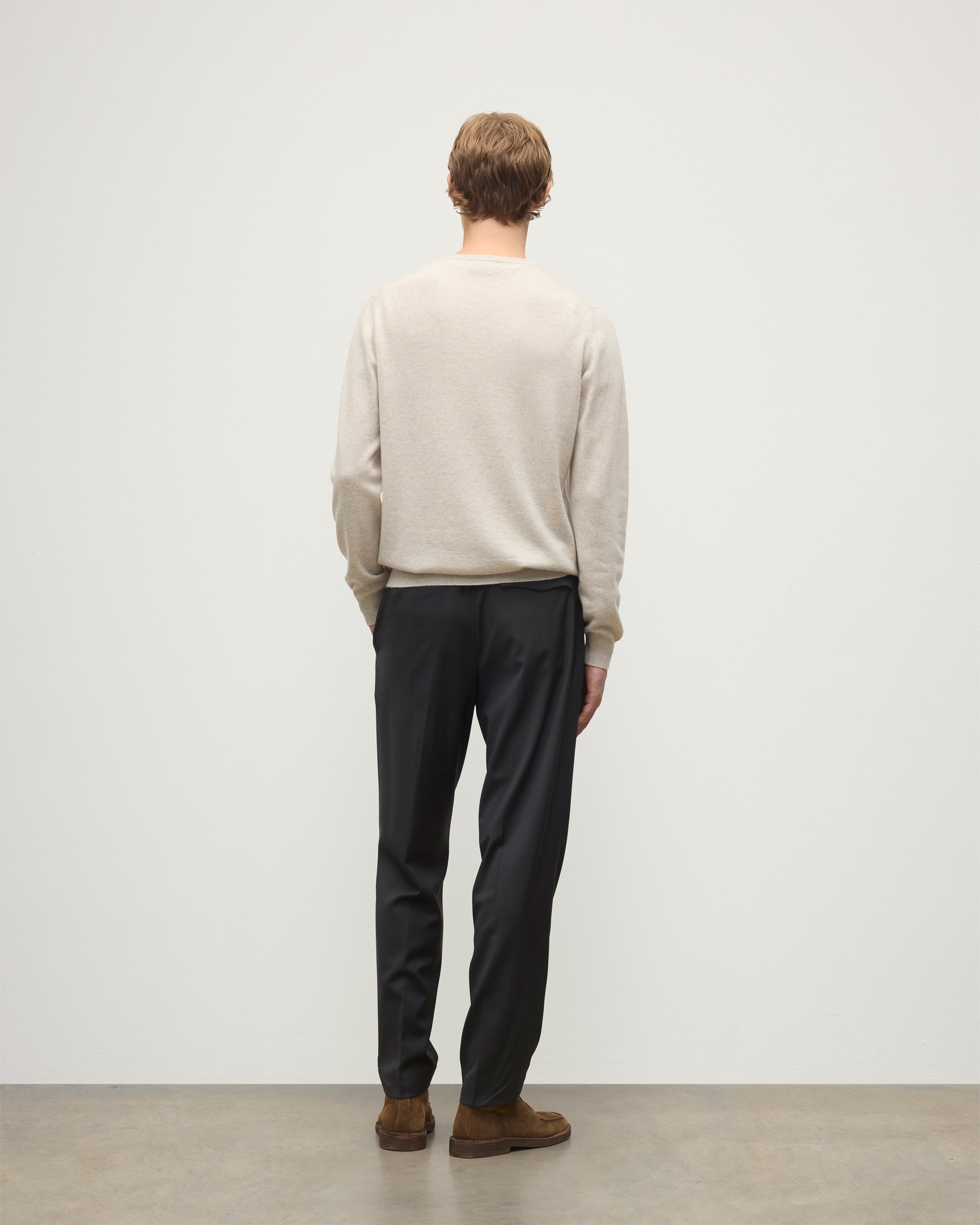 MODEL WEARS JOHNSTONS OF ELGIN MENS ARGYLL CREW SWEATER NATURAL 100% CASHMERE WITH NAVY TROUSERS KAP05747JU1602