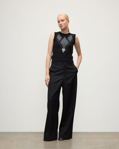 MODEL WEARING JOHNSTONS OF ELGIN WOMENS ARGYLL LE JABOTS SLEEVELESS CREW BLACK 100% CASHMERE WITH BLACK TROUSERS KAP05766JU1609