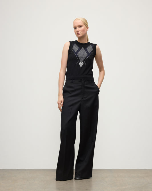 MODEL WEARING JOHNSTONS OF ELGIN WOMENS ARGYLL LE JABOTS SLEEVELESS CREW BLACK 100% CASHMERE WITH BLACK TROUSERS KAP05766JU1609