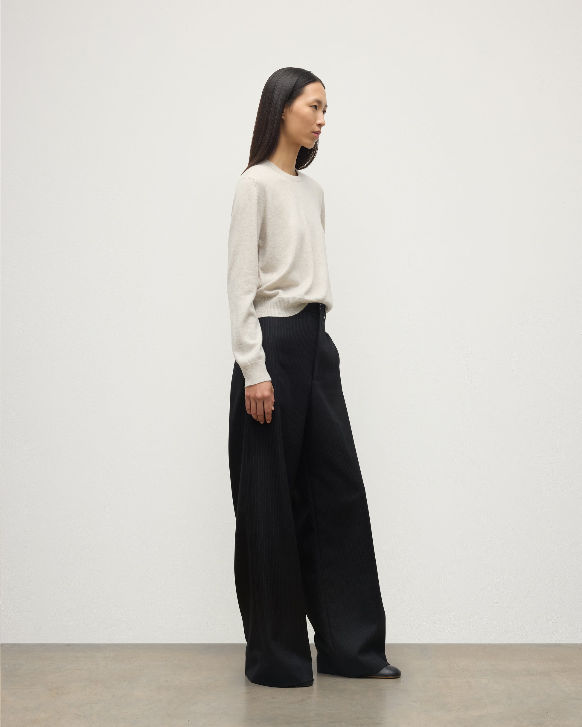 MODEL WEARS JOHNSTONS OF ELGIN WOMENS LUNAN CLASSIC CREW SWEATER NATURAL WITH BLACK WDE LEG TROUSERS KAP05784HA0402