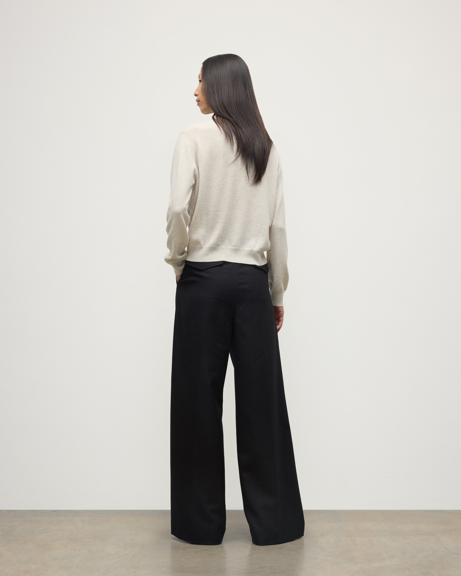 MODEL WEARS JOHNSTONS OF ELGIN WOMENS LUNAN CLASSIC CREW SWEATER NATURAL WITH BLACK WDE LEG TROUSERS KAP05784HA0402