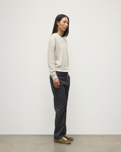 MODEL WEARING JOHNSTONS OF ELGIN WOMENS LUNAN CLASSIC VEE SWEATER NATURAL 100% CASHMERE WITH NAVY TROUSERS KAP05807HA0402