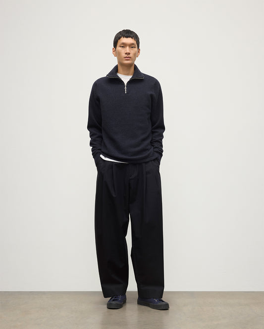 MODEL WEARS JOHNSTONS OF ELGIN MENS TWEEL HALF ZIP SWEATER NAVY & DARK GREY 100% CASHMERE OVER A WHITE T-SHIRT WITH NAVY TROUSERS KAP05832Q25934