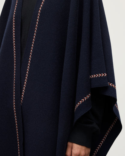 MODEL WEARS JOHNSTONS OF ELGIN WOMENS HAWK PONCHO NAVY 100% CASHMERE KAU05769Q25973O/S