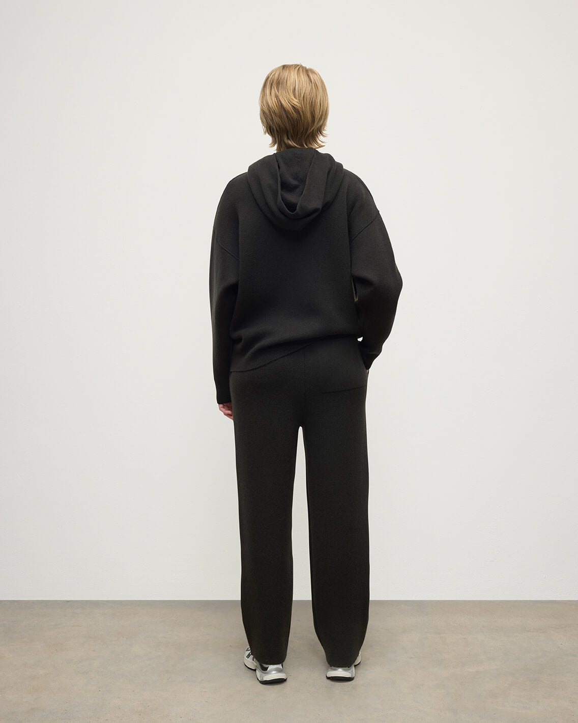 model wears Johnstons of Elgin AW25 Women's Knitwear Iron & Black Double-Face Black Cashmere Hoodie Back View KBA01034Q25336