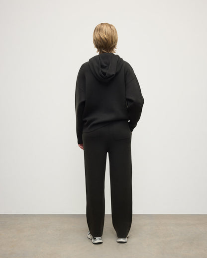 model wears Johnstons of Elgin AW25 Women's Knitwear Iron & Black Double-Face Black Cashmere Hoodie Back View KBA01034Q25336