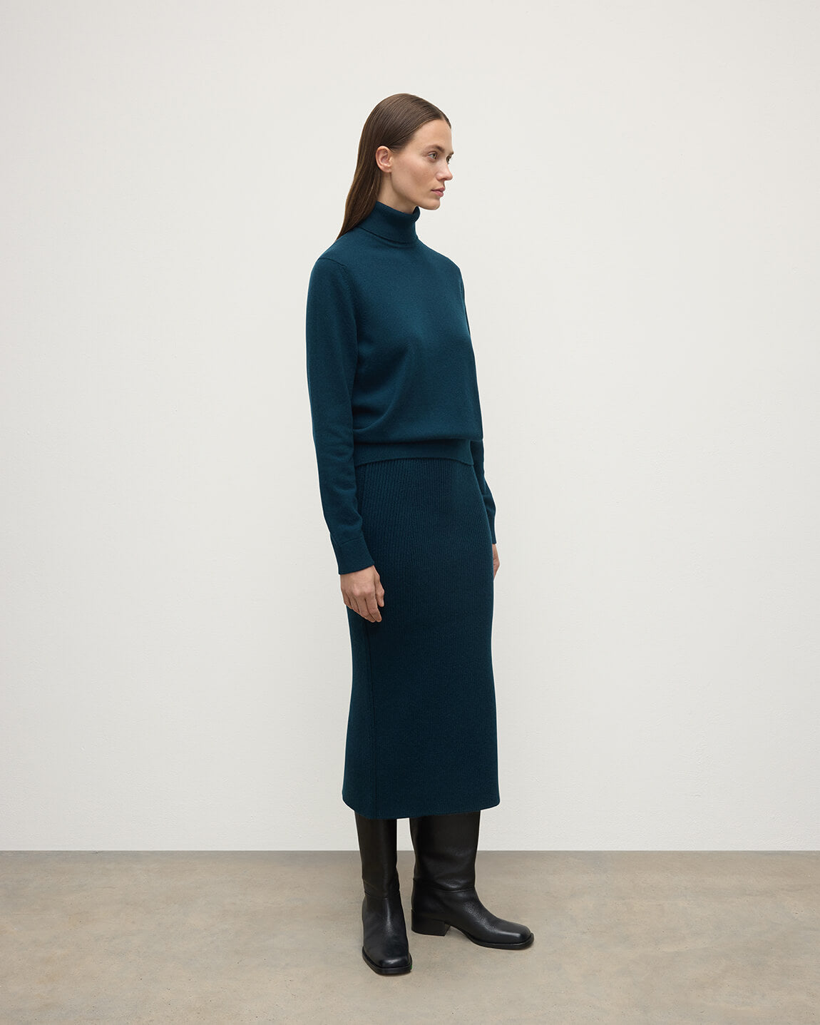 model wears Johnstons of Elgin AW25 Women's Knitwear Bottle Green Cashmere Green Midi Skirt Side View KBC01032SC7341