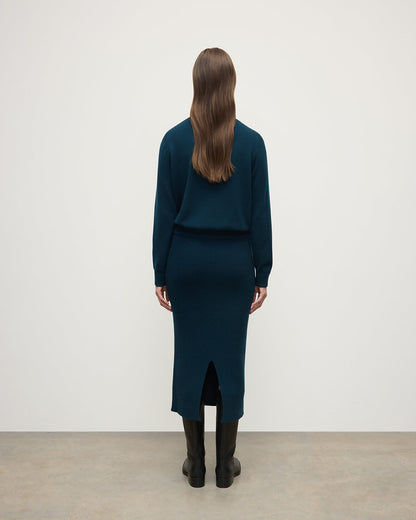model wears Johnstons of Elgin AW25 Women's Knitwear Bottle Green Cashmere Green Midi Skirt Back View KBC01032SC7341