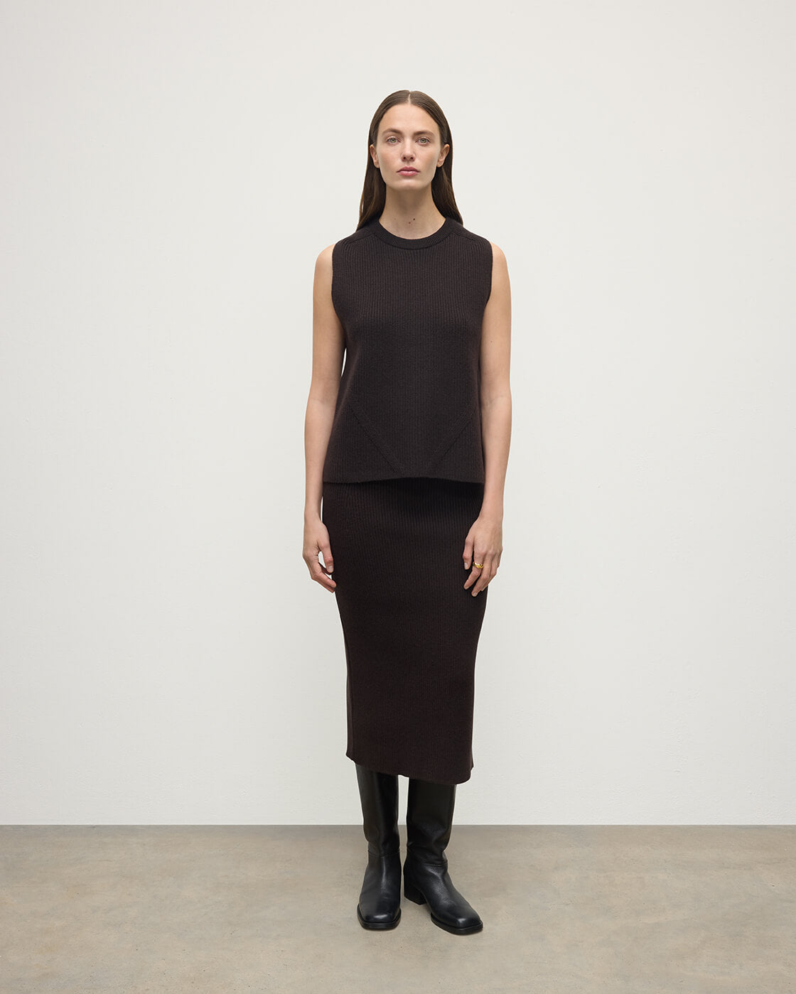 Model wears Johnstons of Elgin AW25 Women's Knitwear Molasses Cashmere Brown Midi Skirt KBC01032SB7290