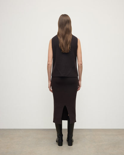 Model wears Johnstons of Elgin AW25 Women's Knitwear Molasses Cashmere Brown Midi Skirt KBC01032SB7290