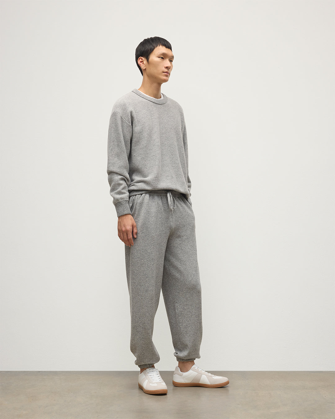 MALE MODEL WEARS JOHNSTONS OF ELGIN MENS KIRK SWEATPANTS LIGHT GREY 97% CASHMERE 3% POLYESTER WITH LIDDEL CASHMERE SWEATSHIRT KBP00948HA0308