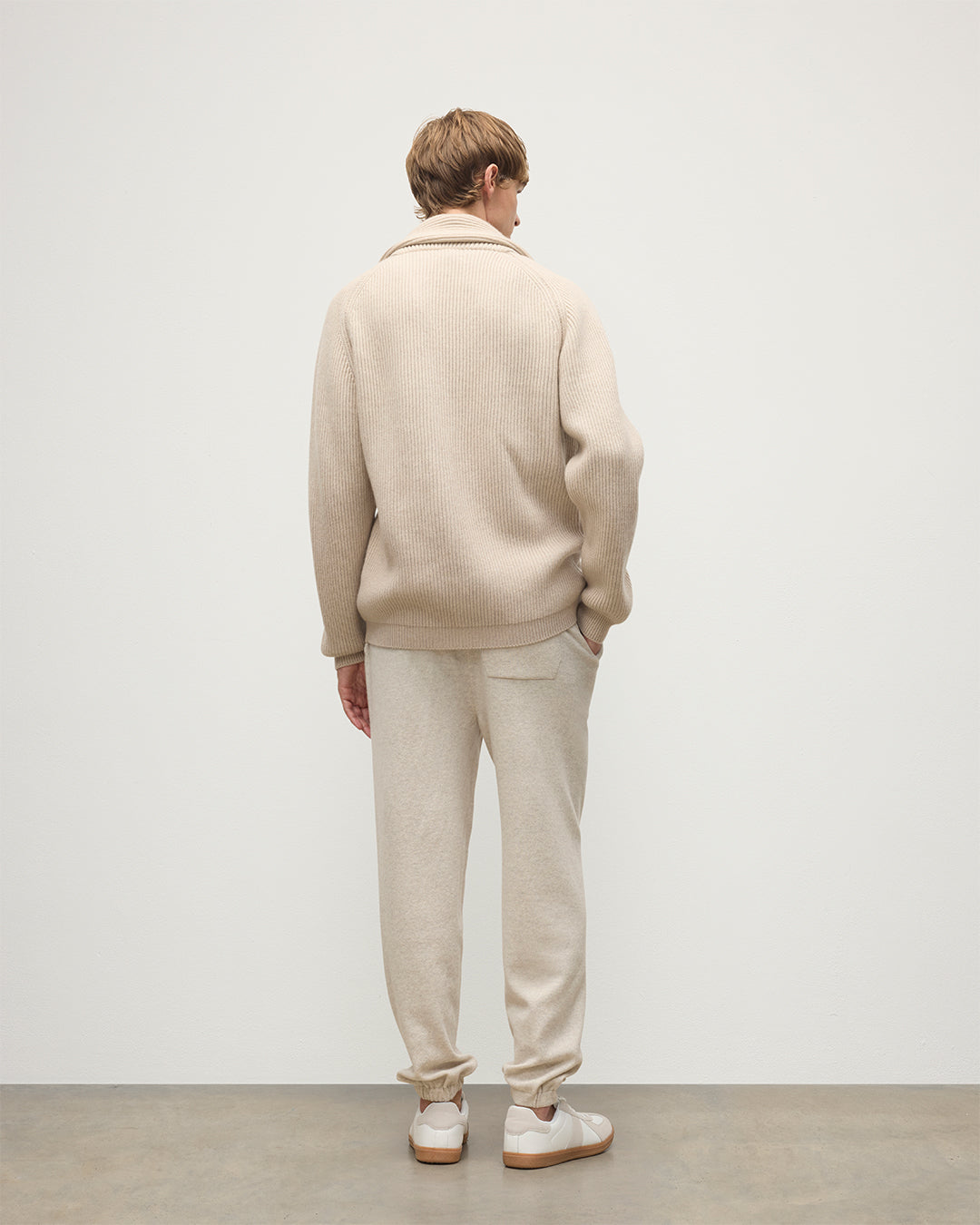 MODEL WEARING JOHNSTONS OF ELGIN MENS KIRK SWEATPANTS NATURAL 97% CASHMERE 3% POLYESTER WITH A WHITE T-SHIRT AND PIONEER CASHMERE CARDIGNA IN NATURAL KBP00948HA0402