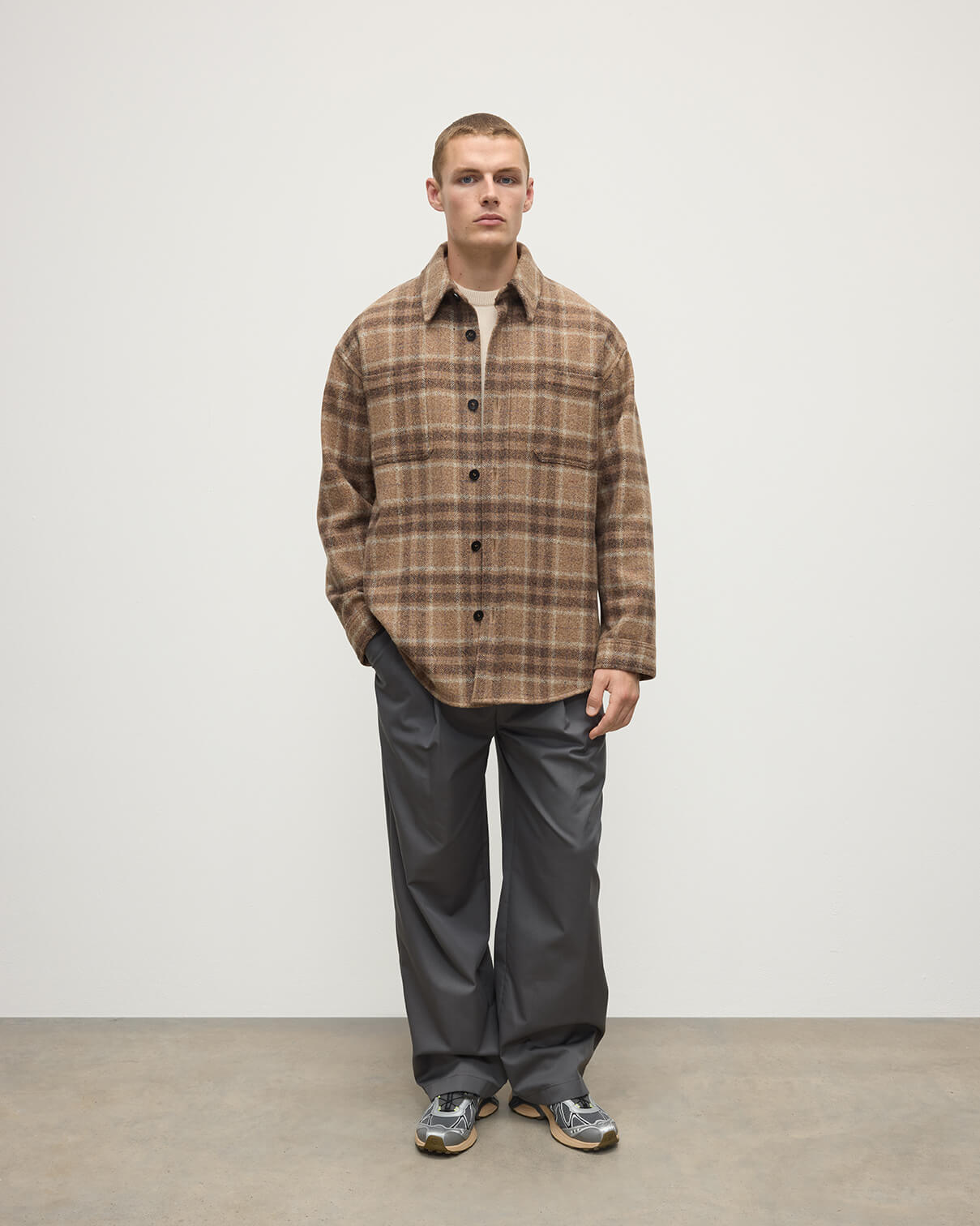 Model wears Johnstons of Elgin AW25 Men's Tailoring Vicuna Tweed Check Cashmere Wool Blend Brown Overshirt TB000755RU7683
