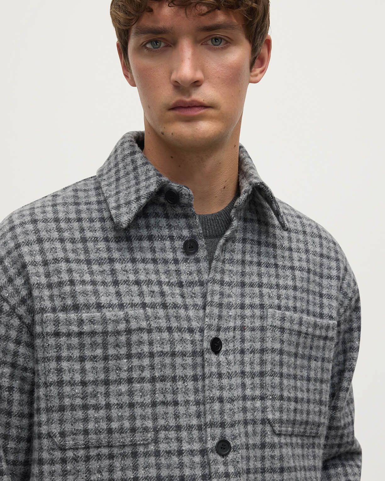 Close up of a model wearing Johnstons of Elgin AW25 Men's Tailoring Grey Classic Gunclub Cashmere Wool Blend Grey Overshirt TB000755RU7684