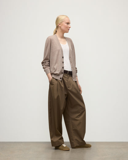 FEMALE MODEL WEARING JOHNSTONS OF ELGIN FORSYTH SUPERFINE VEE NECK CARDIGAN LIGHT BROWN WITH BROWN WIDE LEG TROUSERS UAI05740HB0273