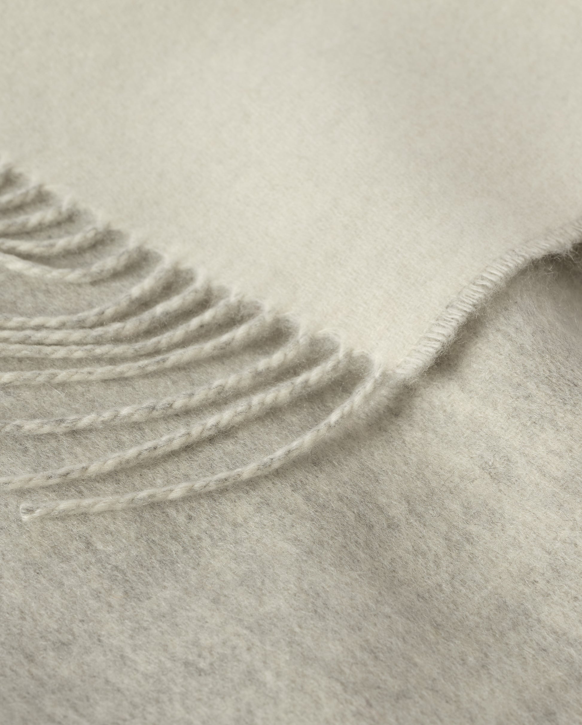 Johnstons of Elgin Light Grey & White reversible blanket on a grey background WA000013RU5059ONE